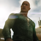Black Adam standing against a building and sky